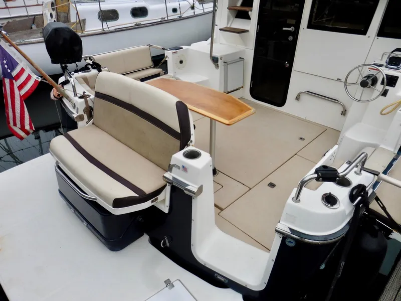 Slide: The Image of 2015 Cutwater 30CB boat interior with seating, table, and American flag. - 30