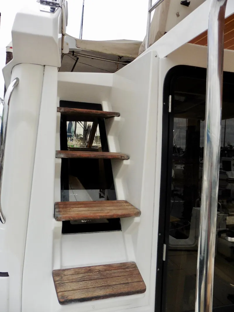 Slide: The Image of Staircase on 2015 Cutwater 30CB boat, featuring wooden steps and sleek design. - 31