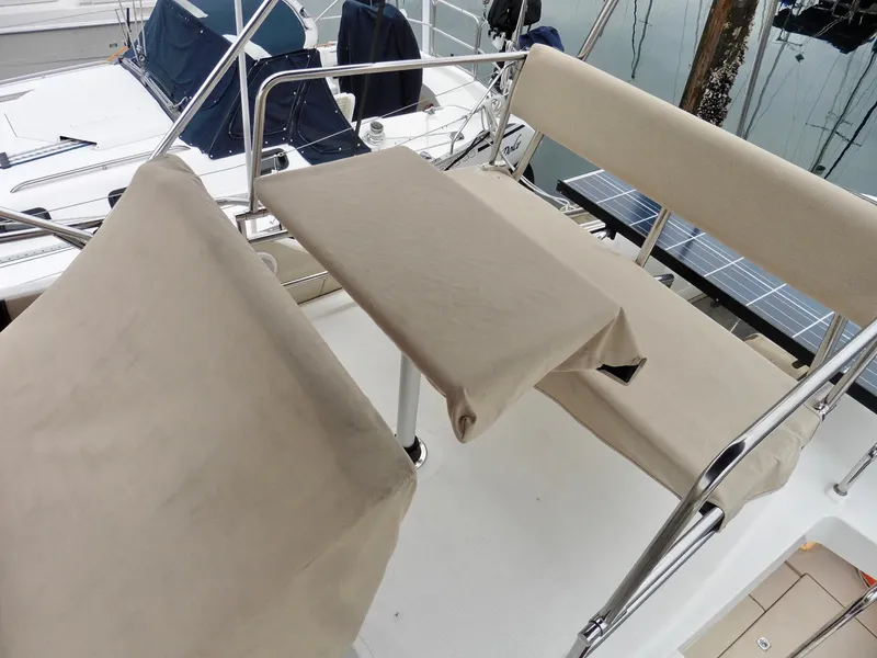 Slide: The Image of 2015 Cutwater 30CB boat seating area with beige covers and metal railings. - 33