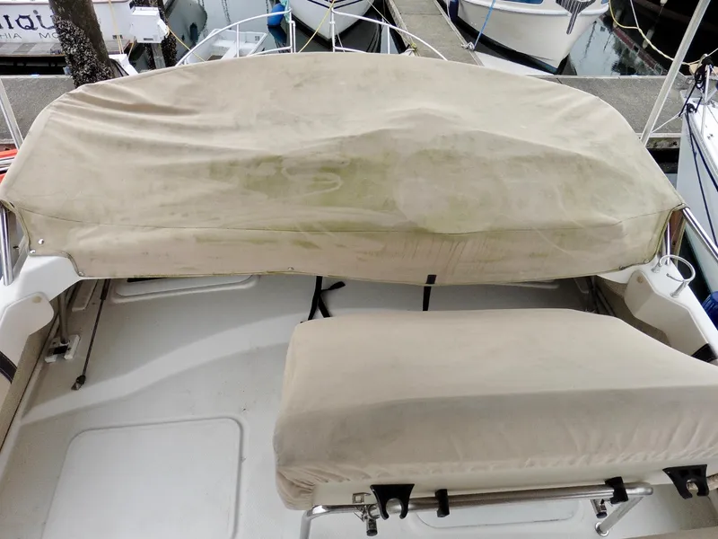 Slide: The Image of Covered seating area on a 2015 Cutwater 30CB boat at a marina. - 34