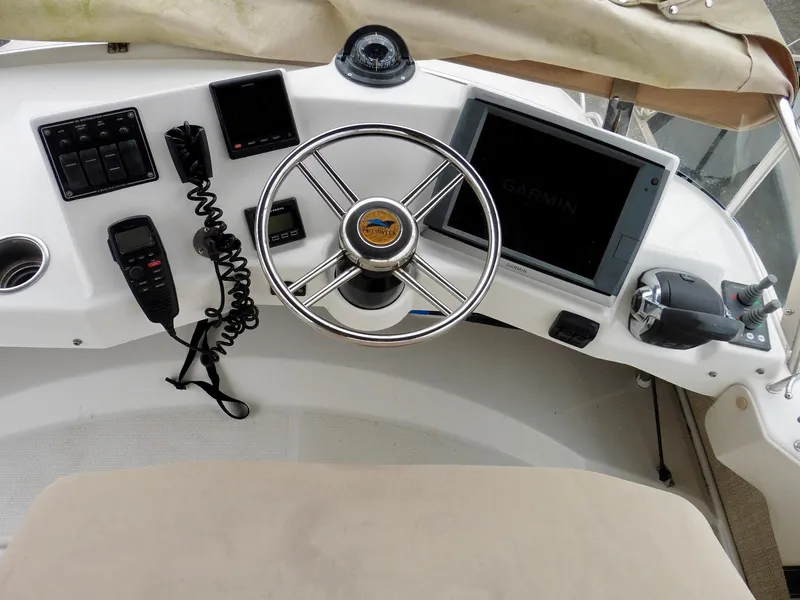 Slide: The Image of Helm of 2015 Cutwater 30CB boat with steering wheel and navigation equipment. - 35