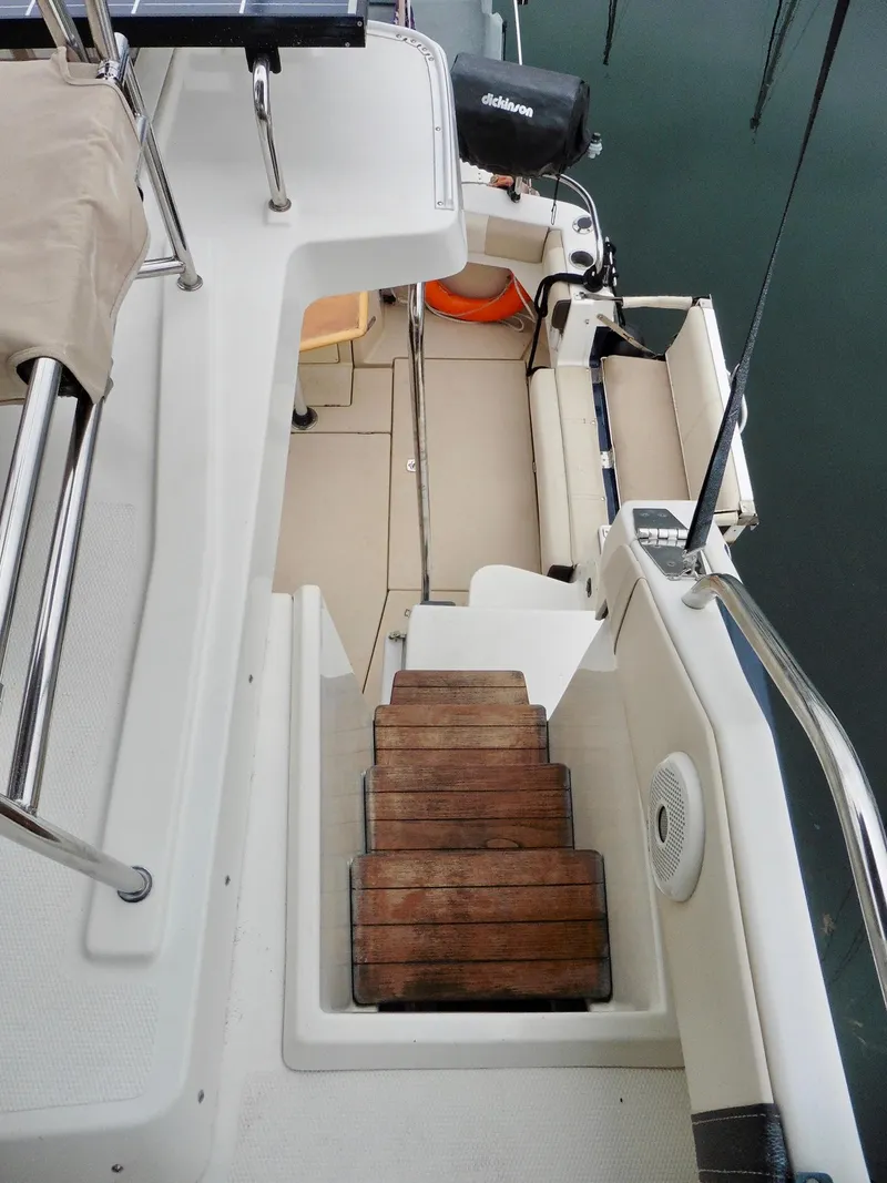 Slide: The Image of 2015 Cutwater 30CB boat interior with wooden steps and seating area. - 40