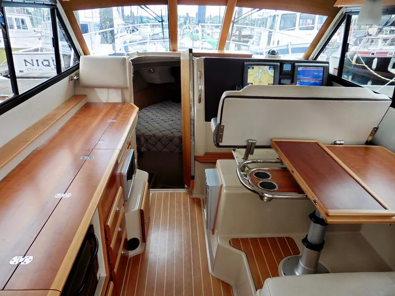 Slide: The Image of 2015 Cutwater 30CB interior with wood finishes, navigation screens, and cozy cabin space. - 41