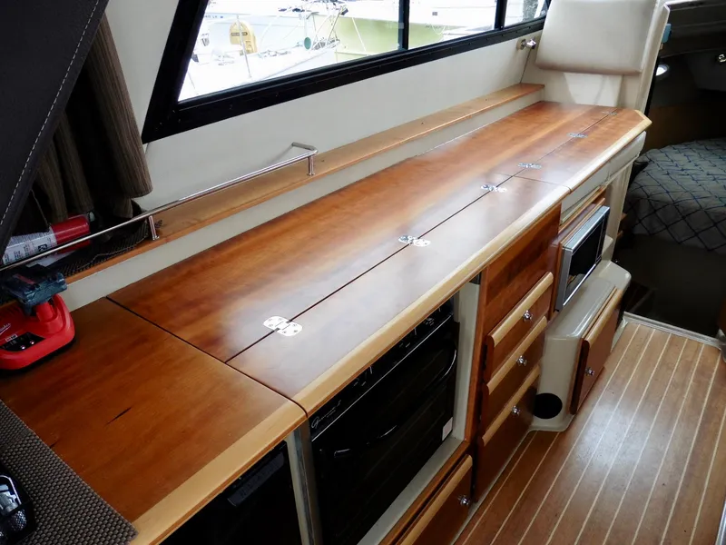 Slide: The Image of 2015 Cutwater 30CB interior with wooden cabinetry and modern appliances. - 43