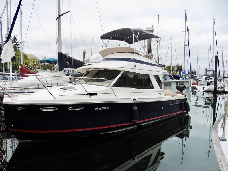 Slide: The Image of 2015 Cutwater 30CB yacht docked in marina, surrounded by sailboats. - 6