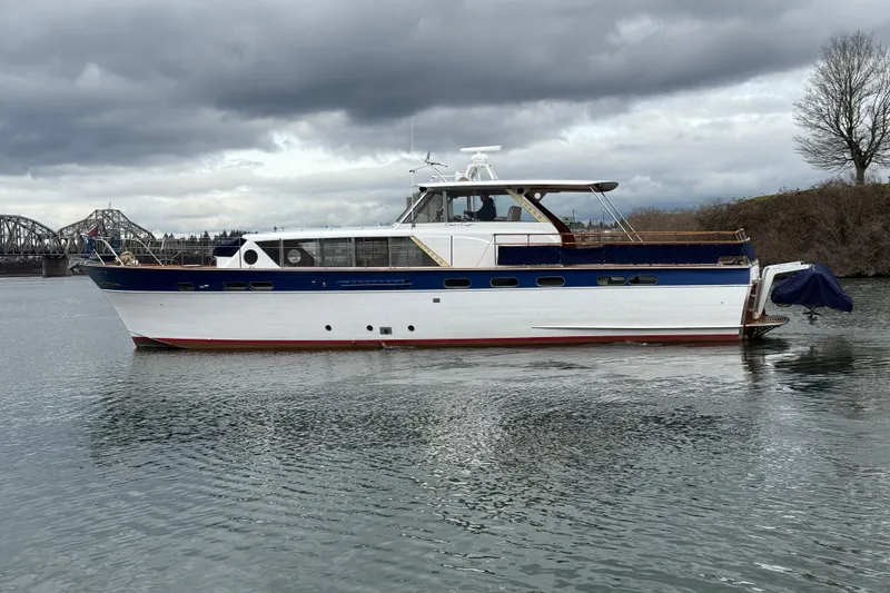 The Image of 1961 Chris-Craft 55 yacht on calm water under cloudy skies. - 0
