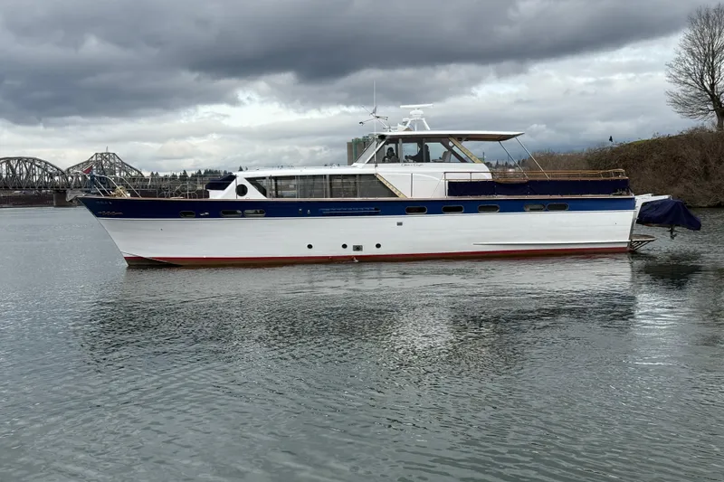 Slide: The Image of 1961 Chris-Craft 55 yacht on calm water under cloudy skies. - 11