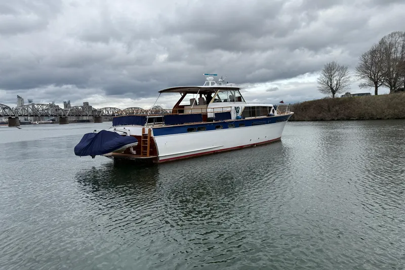 Slide: The Image of 1961 Chris-Craft 55 yacht on a calm river under cloudy skies. - 20