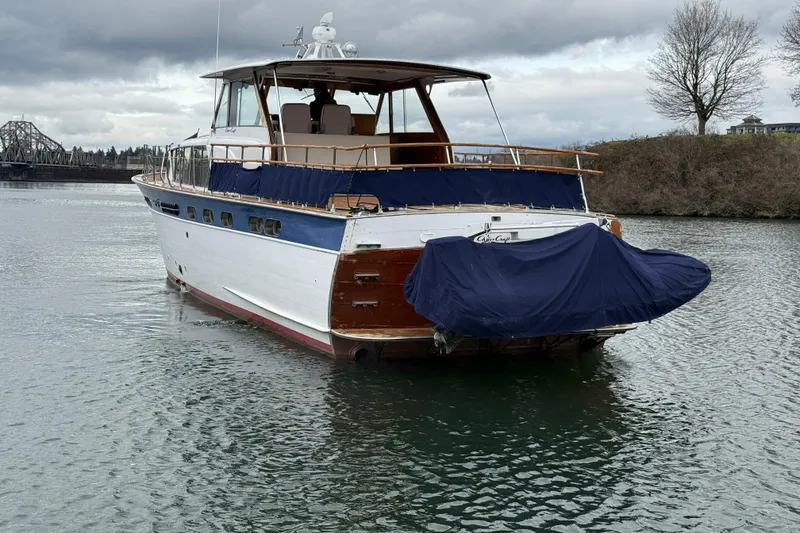Slide: The Image of 1961 Chris-Craft 55 yacht on calm water, overcast sky, and scenic background. - 22