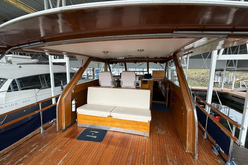 Slide: The Image of 1961 Chris-Craft 55 yacht interior with wooden deck and seating area. - 24