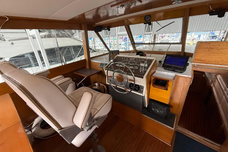 Slide: The Image of Interior of a 1961 Chris-Craft 55 yacht with vintage helm and modern navigation equipment. - 25