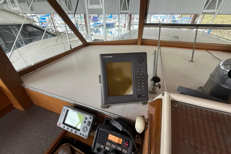 Slide: The Image of Helm of 1961 Chris-Craft 55 with navigation equipment and marina view. - 27