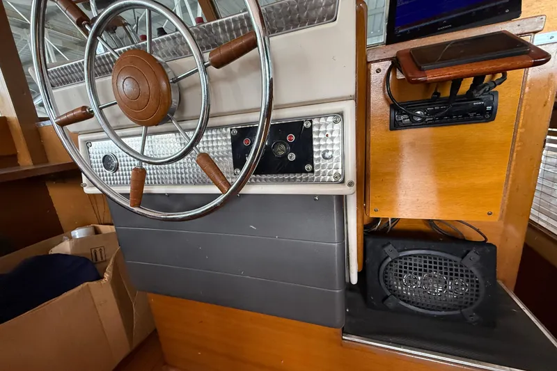 Slide: The Image of 1961 Chris-Craft 55 helm with vintage steering wheel and control panel. - 31