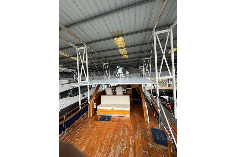 Slide: The Image of 1961 Chris-Craft 55 yacht with wooden deck under covered dock. - 34