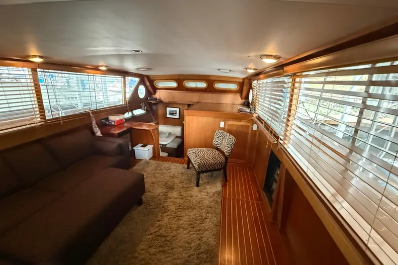 Slide: The Image of Luxurious interior of a 1961 Chris-Craft 55 yacht with wood paneling and cozy seating. - 35