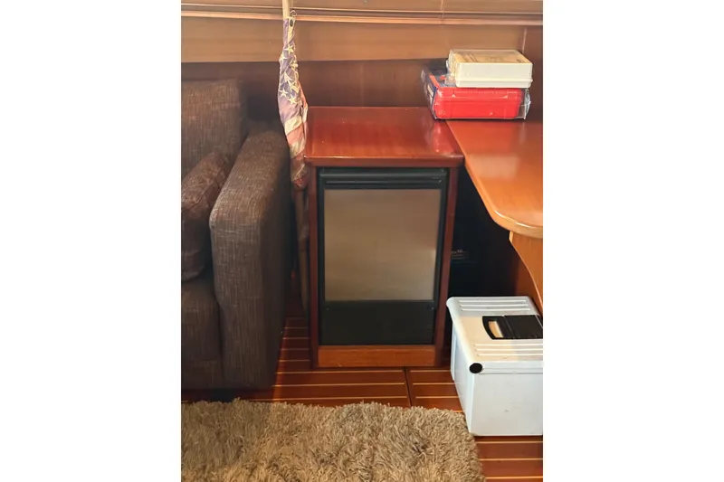 Slide: The Image of Interior of 1961 Chris-Craft 55 yacht with wooden furniture and mini fridge. - 37