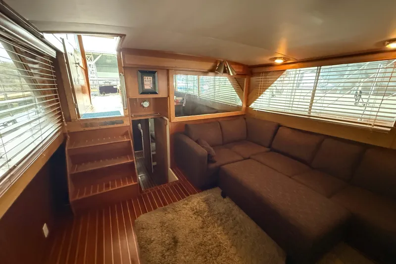 Slide: The Image of Luxurious interior of a 1961 Chris-Craft 55 yacht with cozy seating and wooden accents. - 38