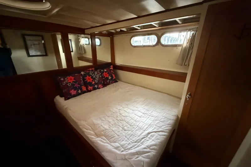 Slide: The Image of Cozy cabin interior of 1961 Chris-Craft 55 yacht with bed and porthole windows. - 51