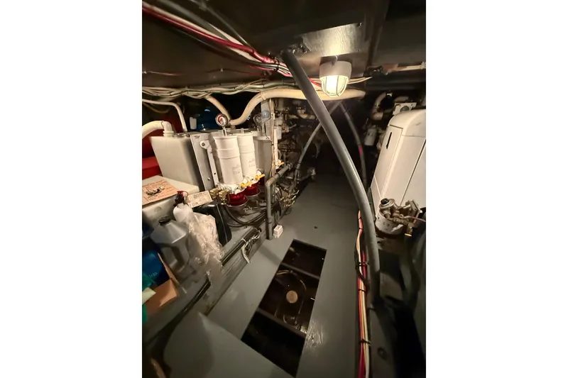 Slide: The Image of Engine room of a 1961 Chris-Craft 55 yacht, showcasing mechanical components and wiring. - 53