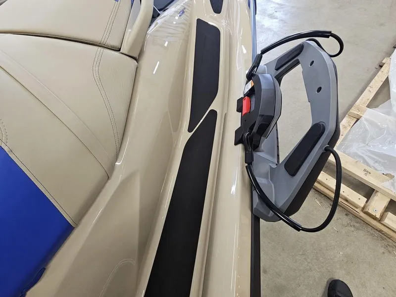 Slide: The Image of 2025 Sea-Doo WAKE™ PRO 230, beige and blue seat, close-up of handle and controls. - 4