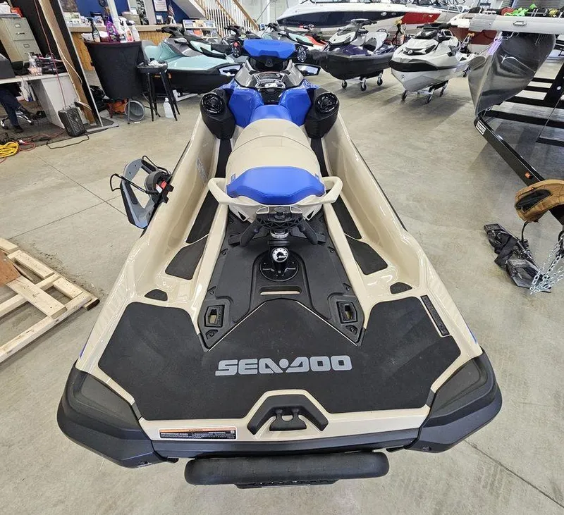 Slide: The Image of 2025 Sea-Doo WAKE™ PRO 230 jet ski in showroom, rear view. - 7