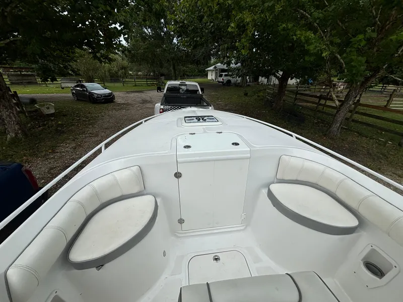 Slide: The Image of 2021 Glasstream 280 SCX boat interior with seating, parked outdoors. - 11