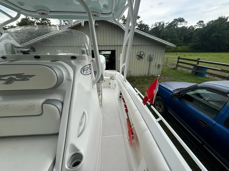 Slide: The Image of 2021 Glasstream 280 SCX boat docked near a barn and blue truck. - 13