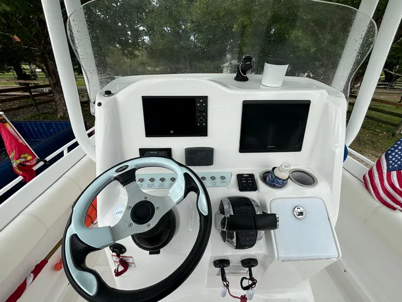 Slide: The Image of 2021 Glasstream 280 SCX boat dashboard with steering wheel and navigation controls. - 15