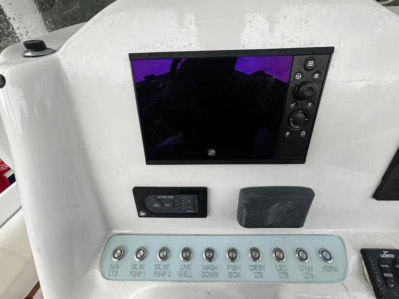 Slide: The Image of 2021 Glasstream 280 SCX dashboard with control panel and display screen. - 16