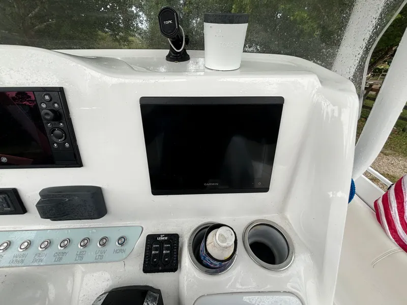 Slide: The Image of 2021 Glasstream 280 SCX boat dashboard with electronics and cup holders. - 17
