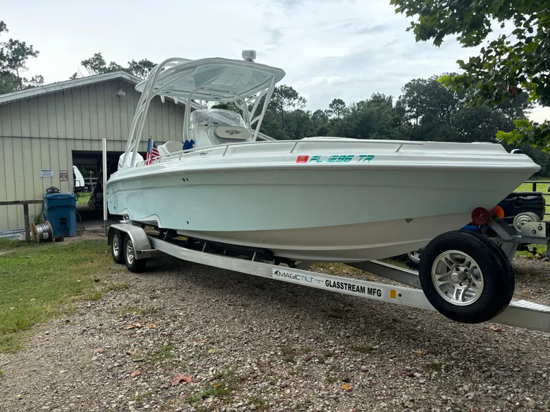 Slide: The Image of 2021 Glasstream 280 SCX boat on trailer near a shed. - 2
