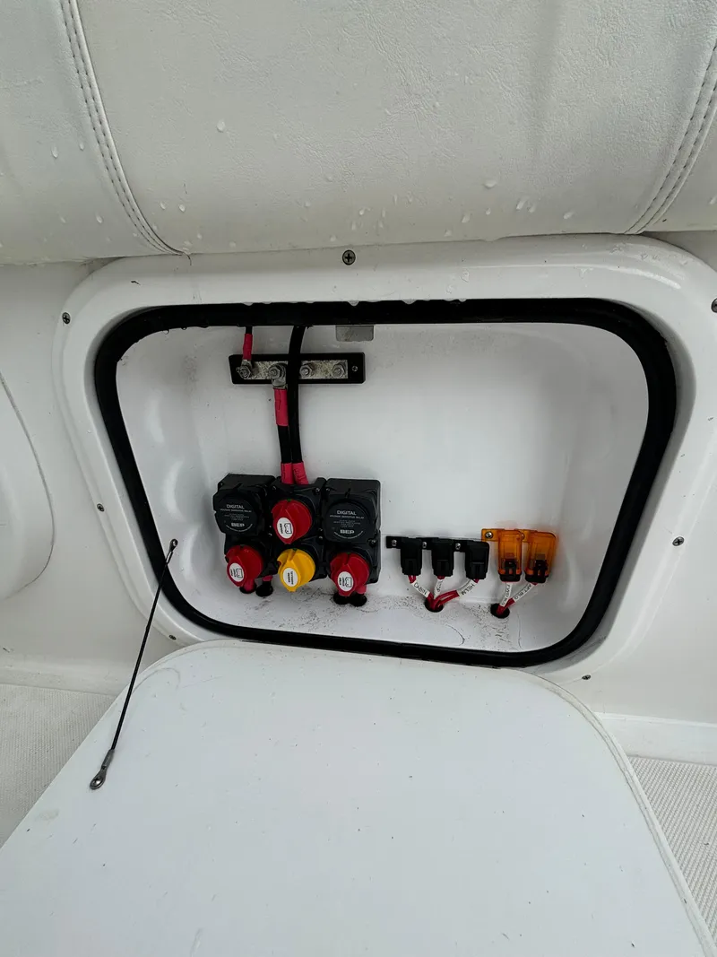 Slide: The Image of 2021 Glasstream 280 SCX electrical panel with switches and wiring. - 26