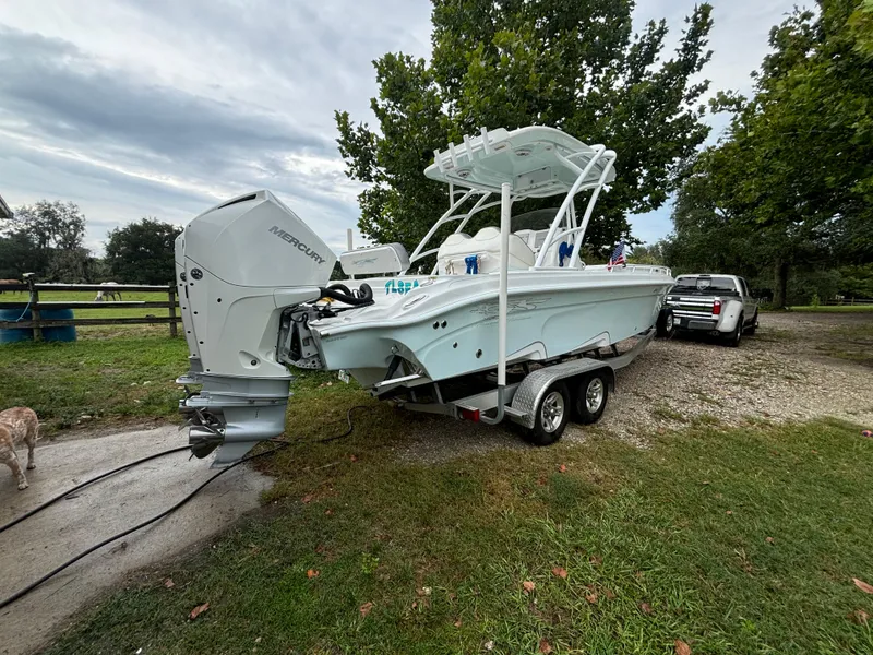 Slide: The Image of 2021 Glasstream 280 SCX boat on trailer, parked outdoors near trees. - 4