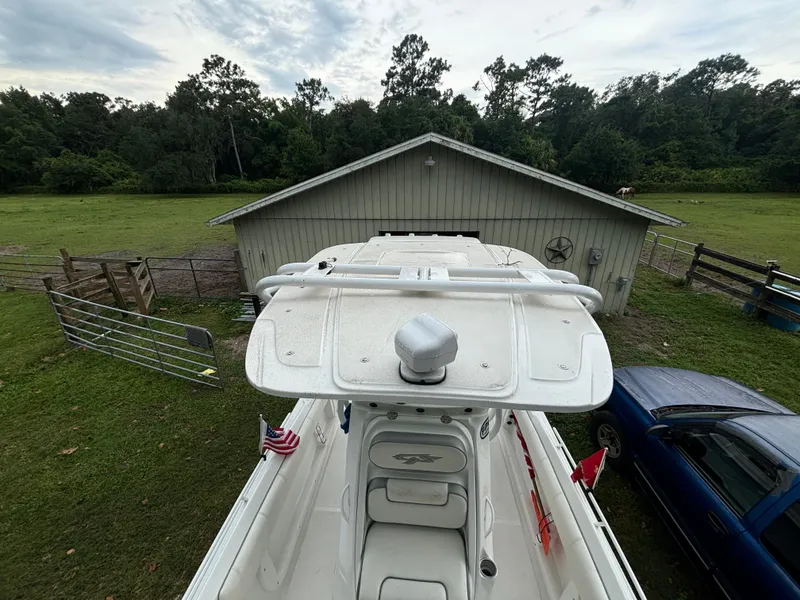 Slide: The Image of 2021 Glasstream 280 SCX boat parked near a barn and a blue vehicle. - 9