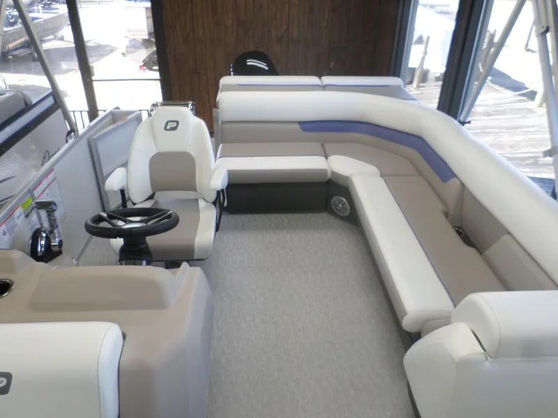 Slide: The Image of 2024 Princecraft Vectra 23 L pontoon boat interior with plush seating and steering console. - 3