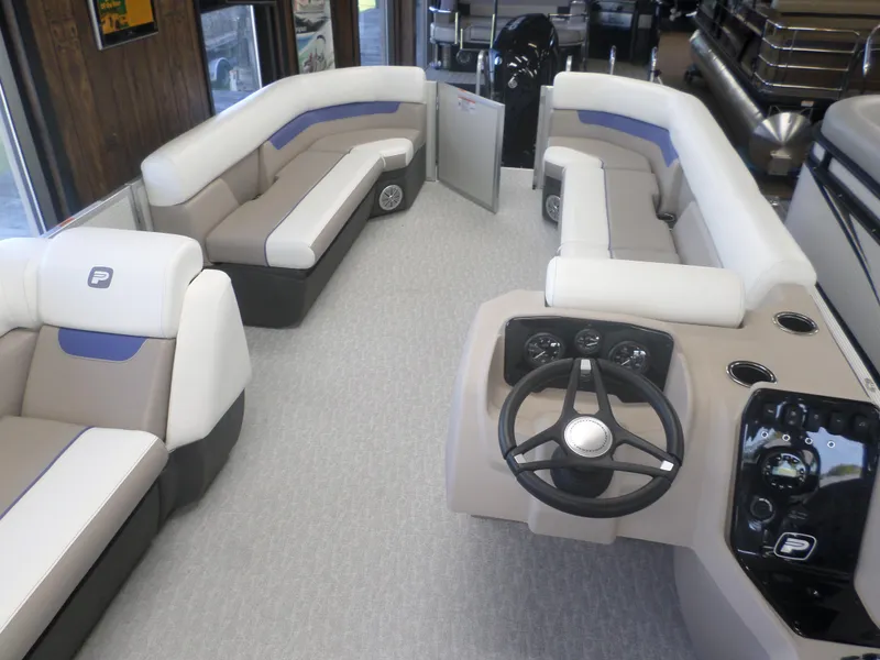 Slide: The Image of 2024 Princecraft Vectra 23 L pontoon boat interior with plush seating and modern dashboard. - 4