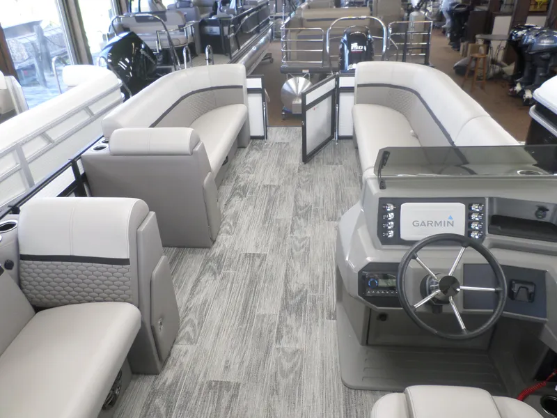 Slide: The Image of 2025 Apex Qwest 8522 Lanai pontoon boat interior with Garmin navigation system. - 3