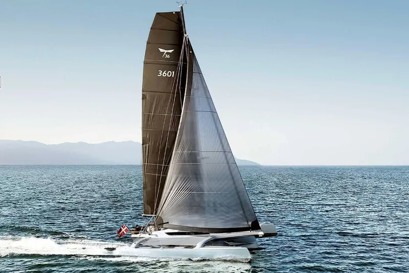 Slide: The Image of Sleek Dragonfly 36 trimaran sailing on open sea, 2026 model. - 1