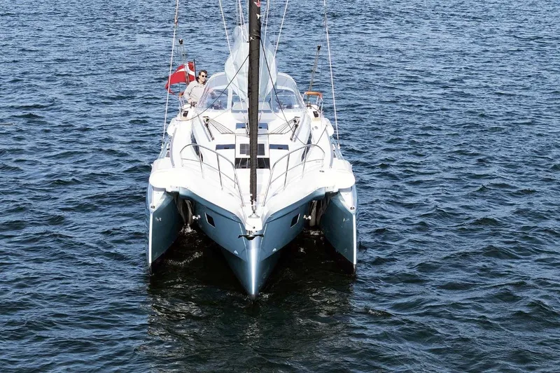 Slide: The Image of 2026 Dragonfly 36 catamaran sailing on open water, featuring sleek design and vibrant flag. - 4