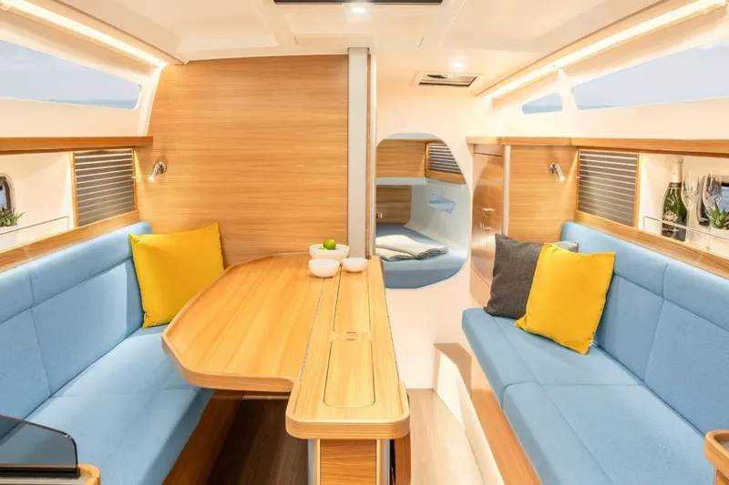 Slide: The Image of Luxurious interior of 2026 Dragonfly 36 yacht with blue seating and wooden accents. - 6