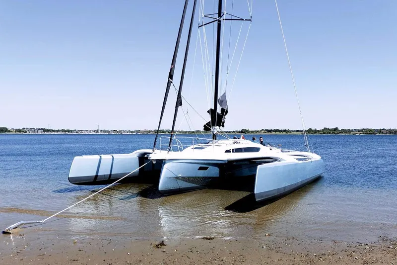 Slide: The Image of Modern Dragonfly 36 trimaran yacht on calm water, 2026 model. - 7