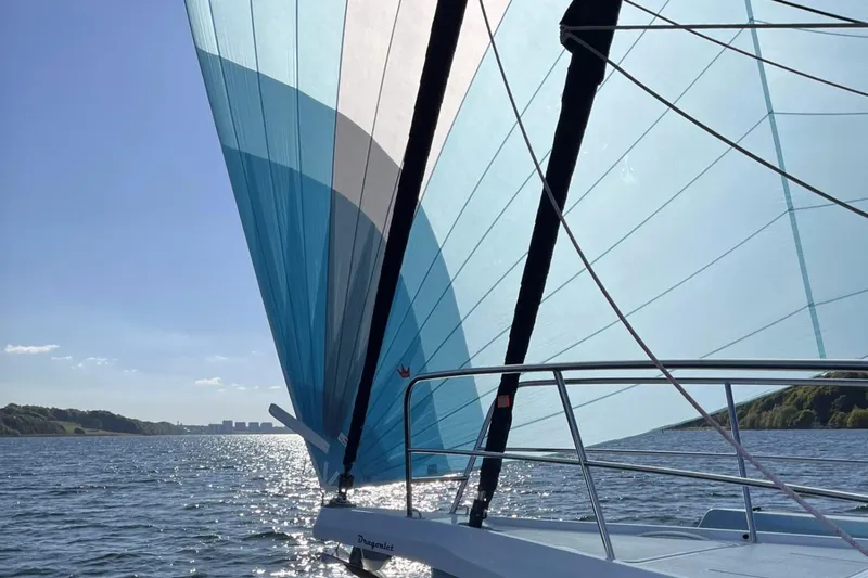 Slide: The Image of Sailing on a Dragonfly 36 yacht, 2026 model, with blue sails on a sunny day. - 3