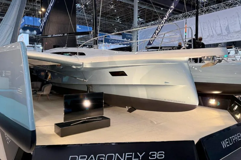 Slide: The Image of 2027 Dragonfly 36 trimaran showcased at a boat exhibition, highlighting sleek design and performance. - 9