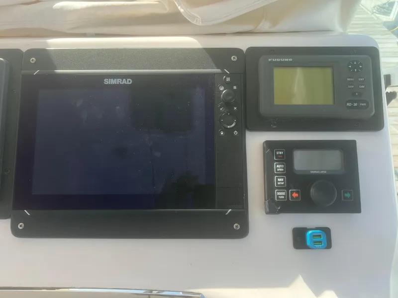 Slide: The Image of Helm of 2003 Cabo Express boat with navigation instruments and steering wheel. - 14