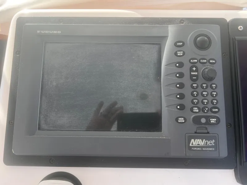 Slide: The Image of Boat dashboard with Simrad and Furuno navigation systems, Cabo Express 2003 model. - 15