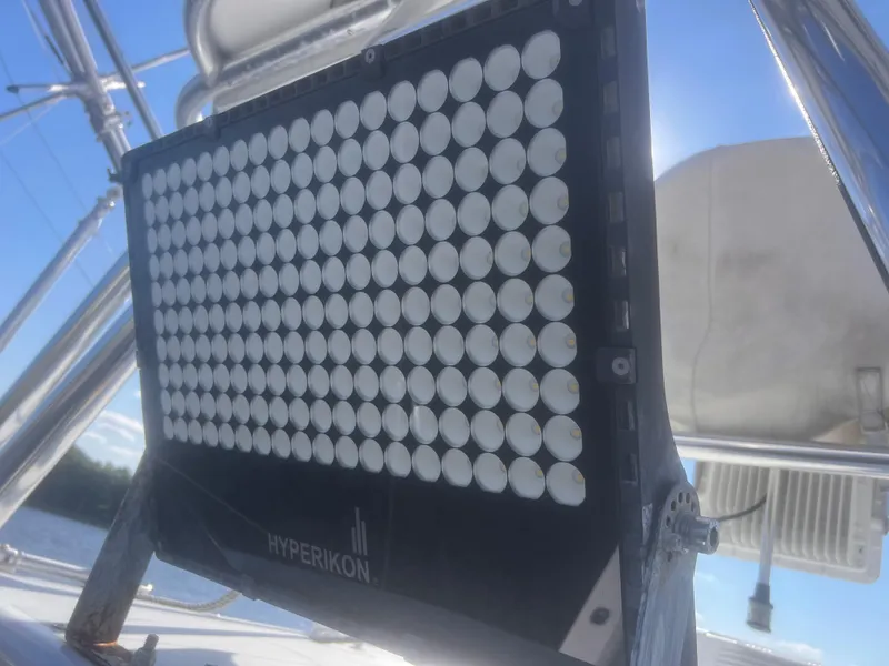 Slide: The Image of 2003 Cabo 35 Express cabin interior with bed, seating, and kitchenette. - 16