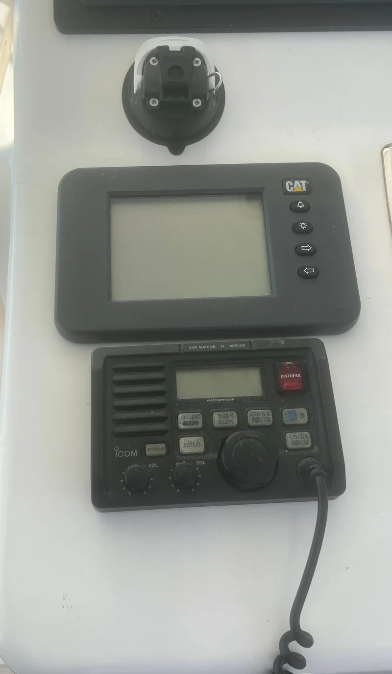 Slide: The Image of 2003 Cabo 35 Express cabin interior with bed, table, and kitchenette. - 17