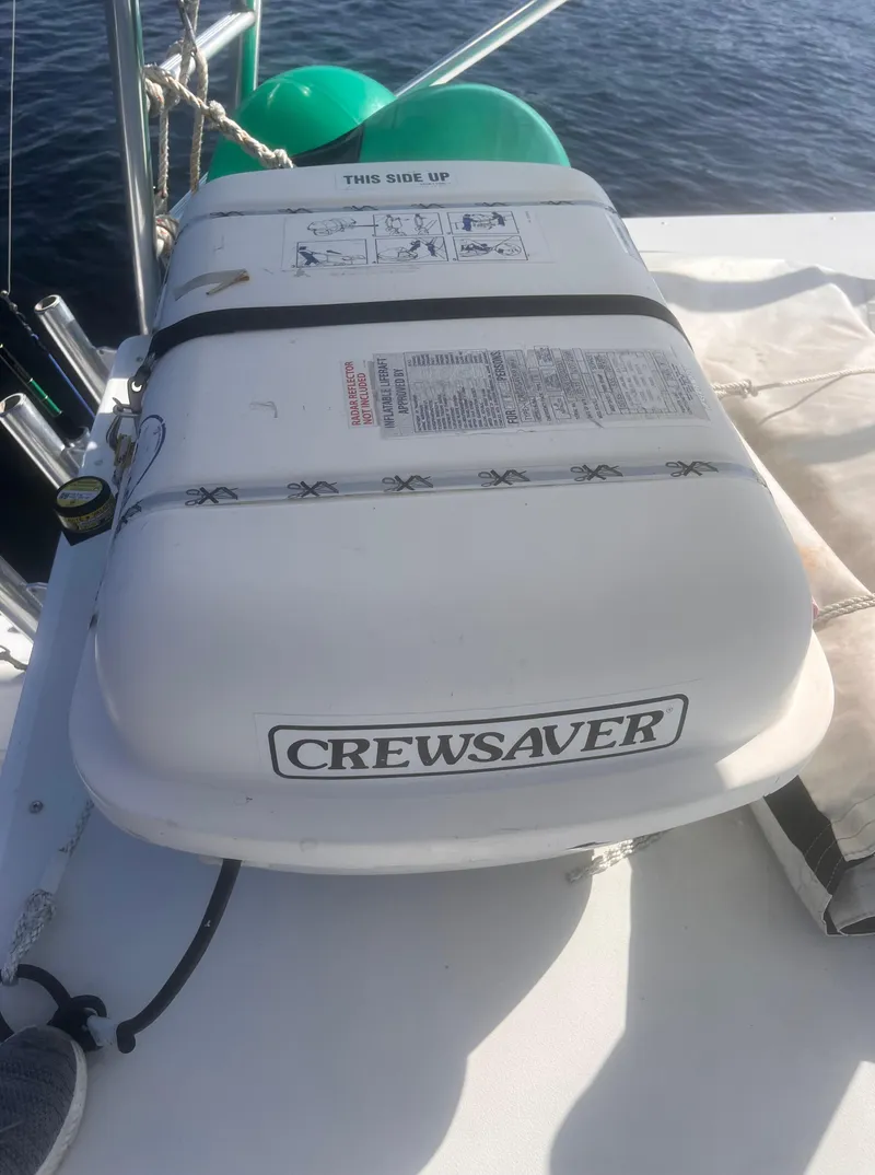 Slide: The Image of 2003 Cabo 35 Express cabin interior with seating, table, and bed. - 19