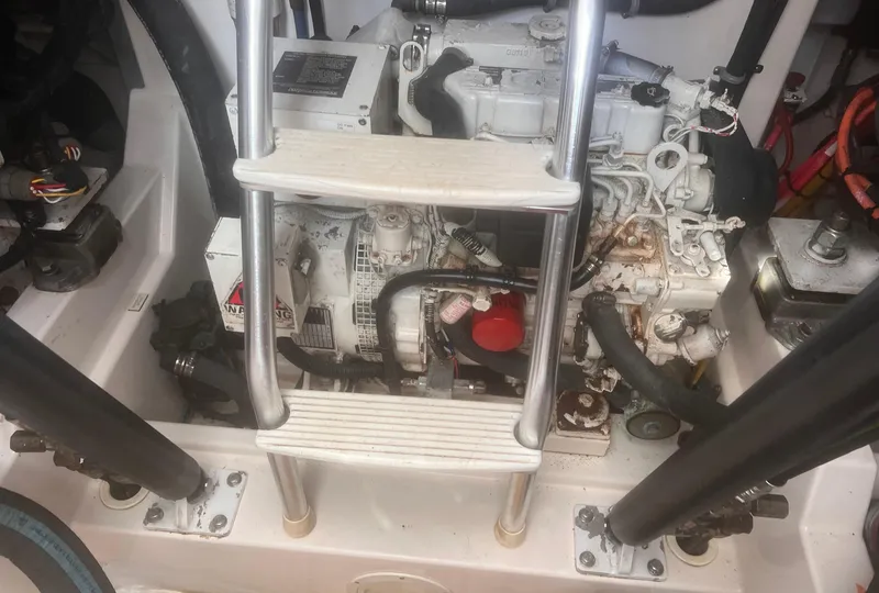 Slide: The Image of Engine compartment of a 2003 Cabo Express boat with visible ladder and components. - 30