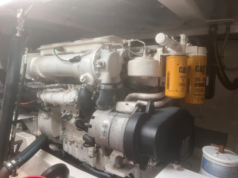 Slide: The Image of Engine of a 2003 Cabo Express boat with visible CAT filters. - 32
